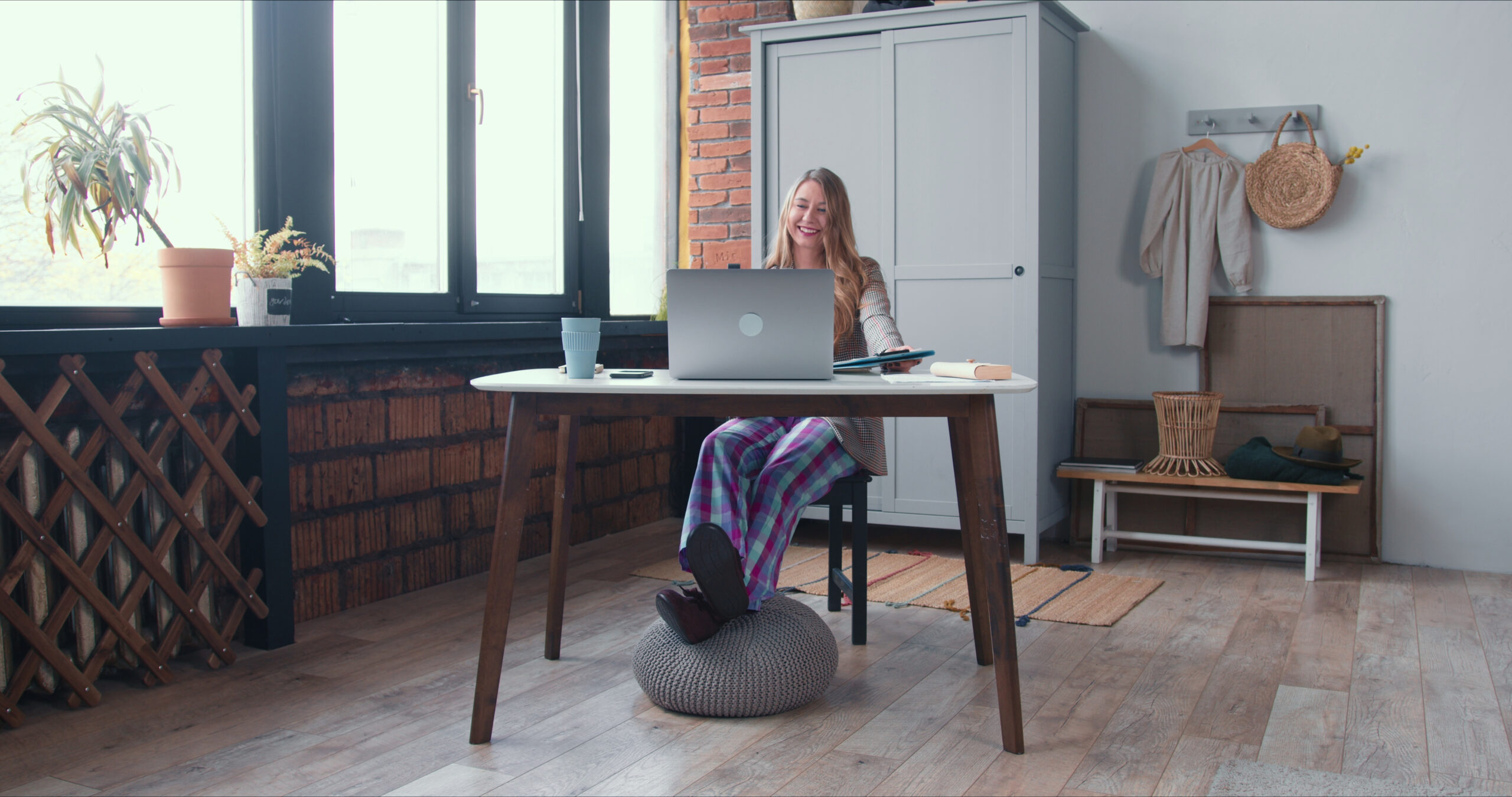 relaxed-work-during-lockdown-young-smiling-blonde-business-woman-in-pajama-pants-works-SBI-350647255